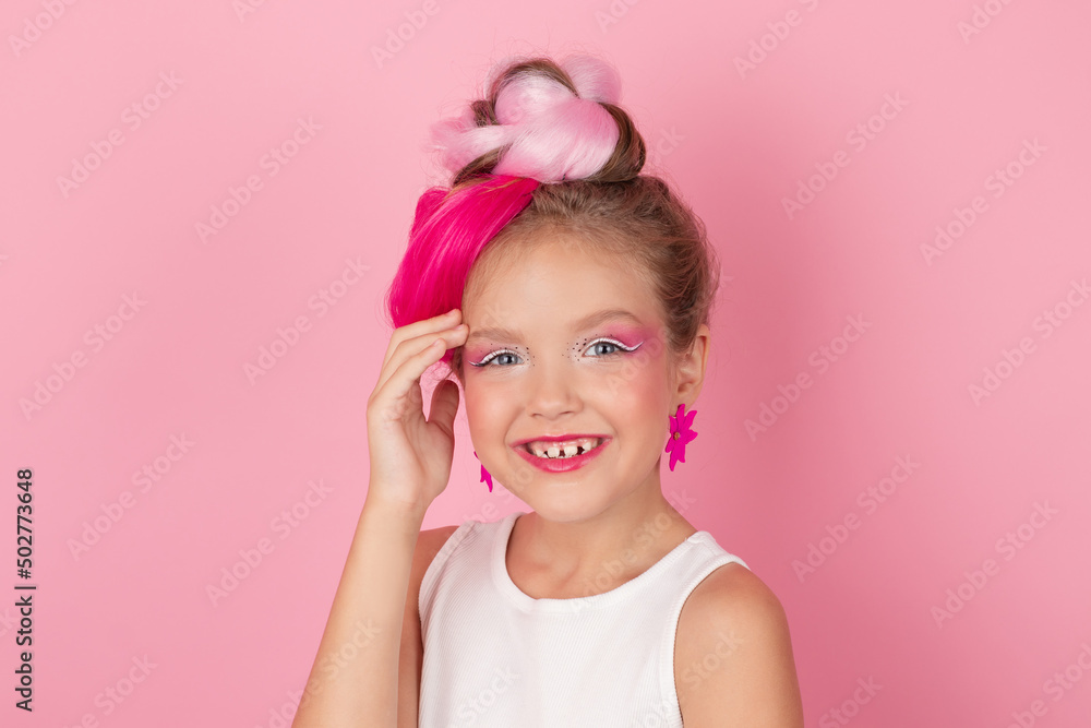 charming little girl with pink hairstyle and pink makeup. tween young model posing on pink background charming little girl with pink hairstyle and pink makeup. tween young model posing on pink background