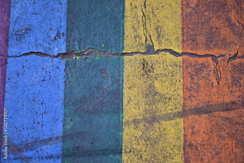 A colorful, zebra crossing with ruptures in Paris in the LGBTQ-district. photo