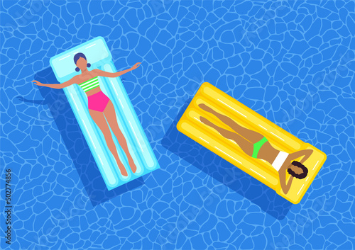 Young women floating on inflatable mattresses in blue swimming pool