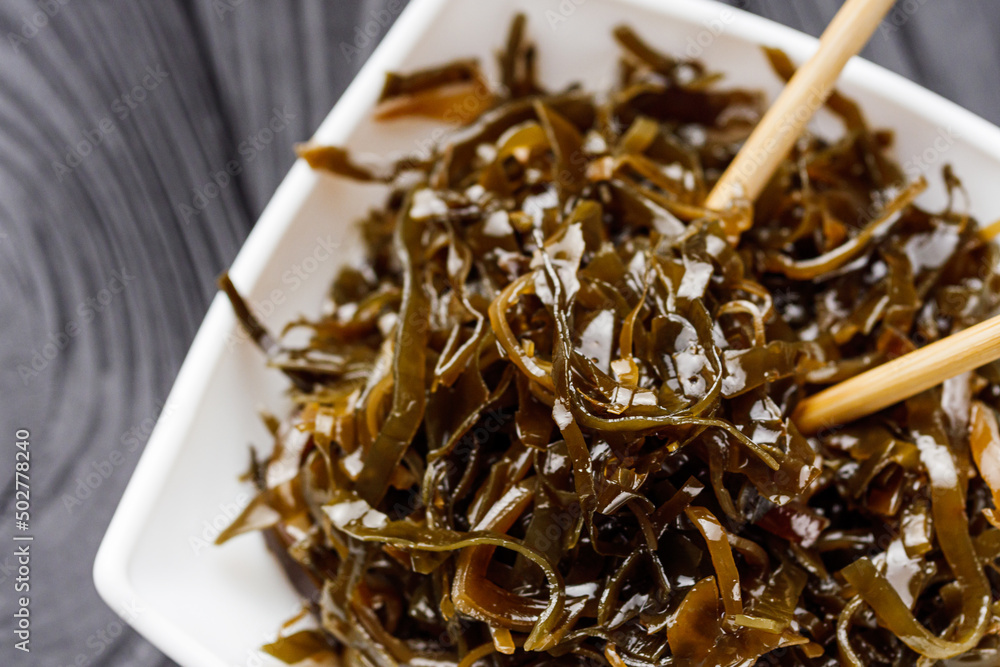 seaweed salad on a black wooden rustic background