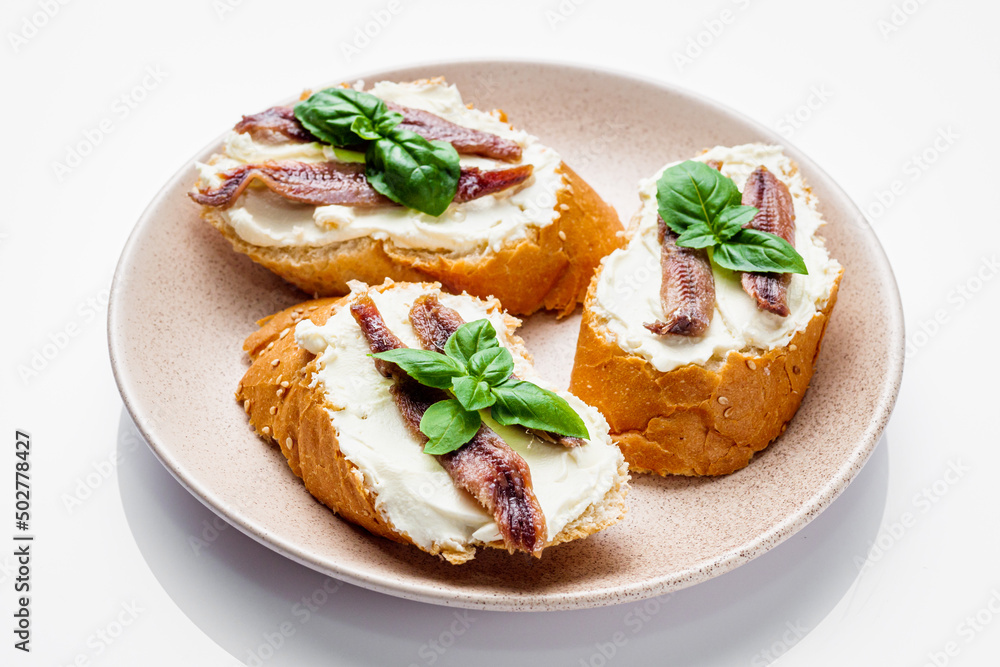 sandwich with anchovy fillets on a serving tray on a white background sandwich with anchovy fillets on a serving tray on a white background