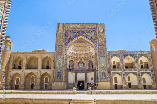 Facade of Abdulaziz Khan Madrasah in Bukhara, Uzbekistan. Built in 17th century. Together with Ulugh Beg madrasah (part of portal is visible on sides of photo) they make up the Kosh-madrasah complex photo