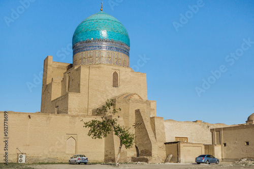 View of the dome of the Miri Arab Madrasah from the side of the street. Blue color of the dome is in harmony with the clear sky. Shot in Bukhara, Uzbekistan