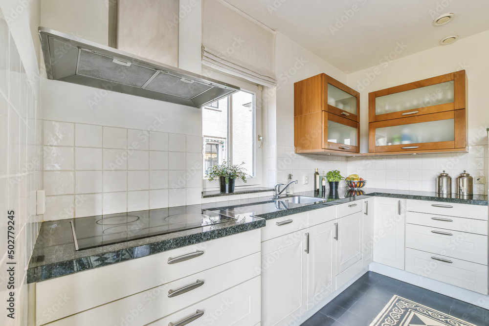 Modern kitchen with built in stove and white furniture Modern kitchen with built in stove and white furniture