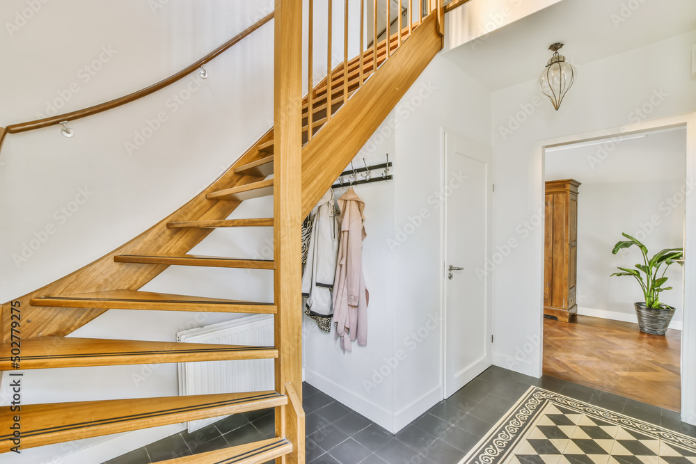 Interior of corridor with wooden staircase at light villa Interior of corridor with wooden staircase at light villa