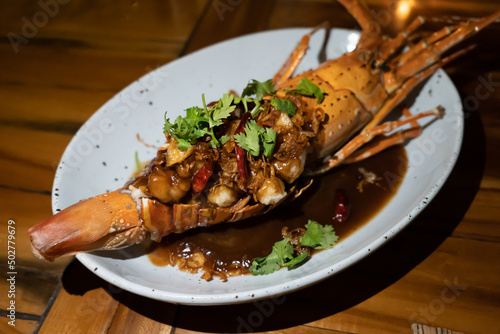 Thai lobster with tamarind sauce and on top with corianders photo