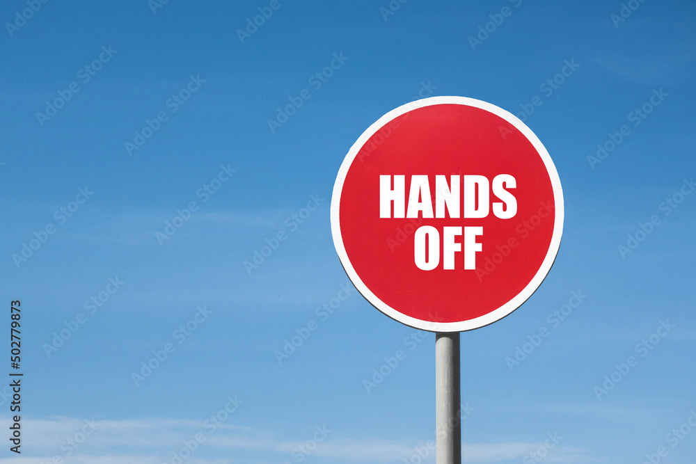 'Hands off' sign in red round frame. Clear blue sky is on background 'Hands off' sign in red round frame. Clear blue sky is on background