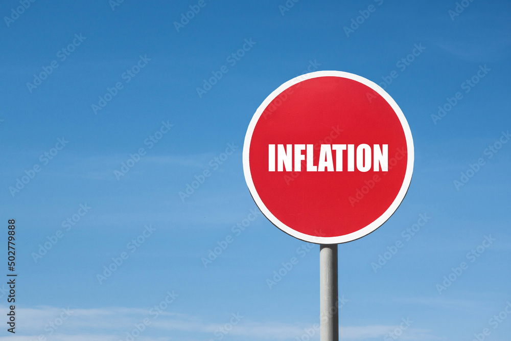 'Inflation' sign in red round frame. Clear sky is on background 'Inflation' sign in red round frame. Clear sky is on background
