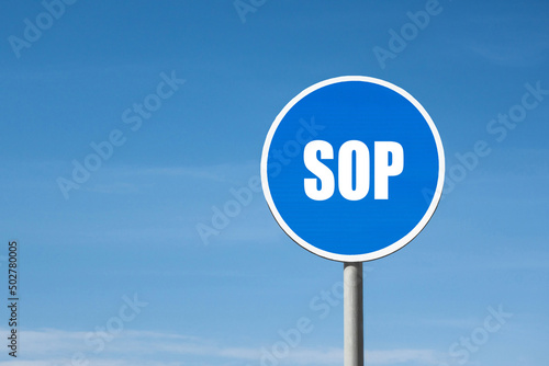 'SOP' sign in blue round frame. Clear sky is on background