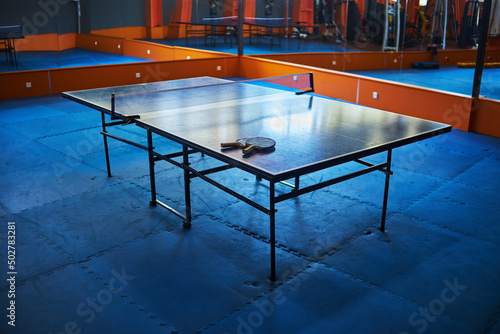 table with table tennis rackets in the gym. selective focus, low depth of focus. a small grain for artistic effect