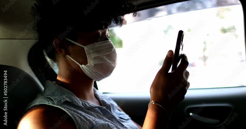 Obraz premium Passenger african descent girl riding taxi wearing virus prevention mask