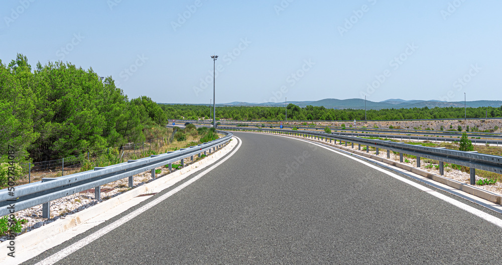 Scenic road. The road is surrounded by a magnificent natural landscape.