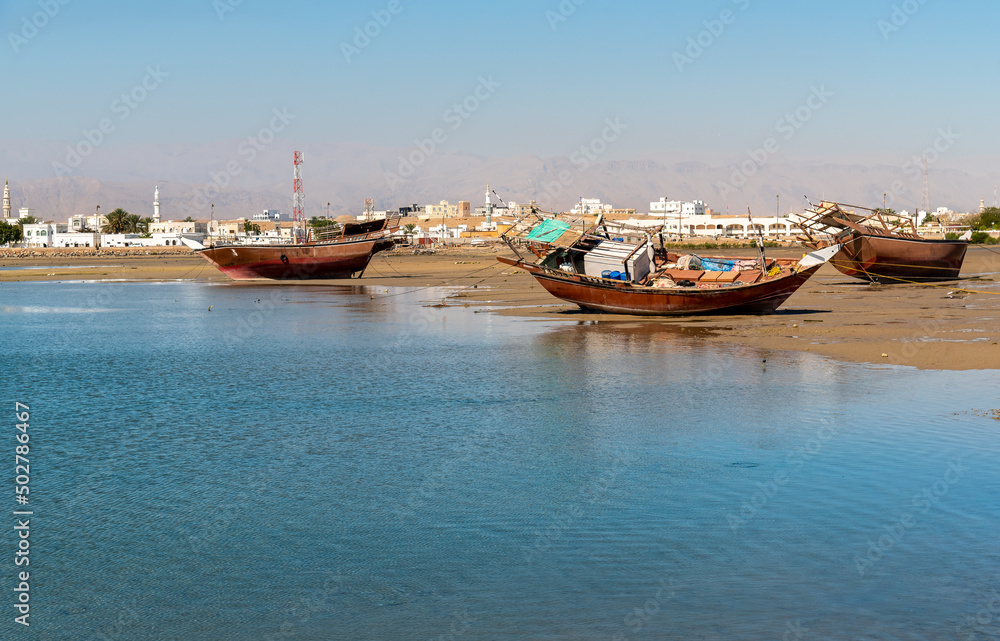 Old abandoned fishing boats in the bay of Sur, Sultanate of Oman in the Middle East.