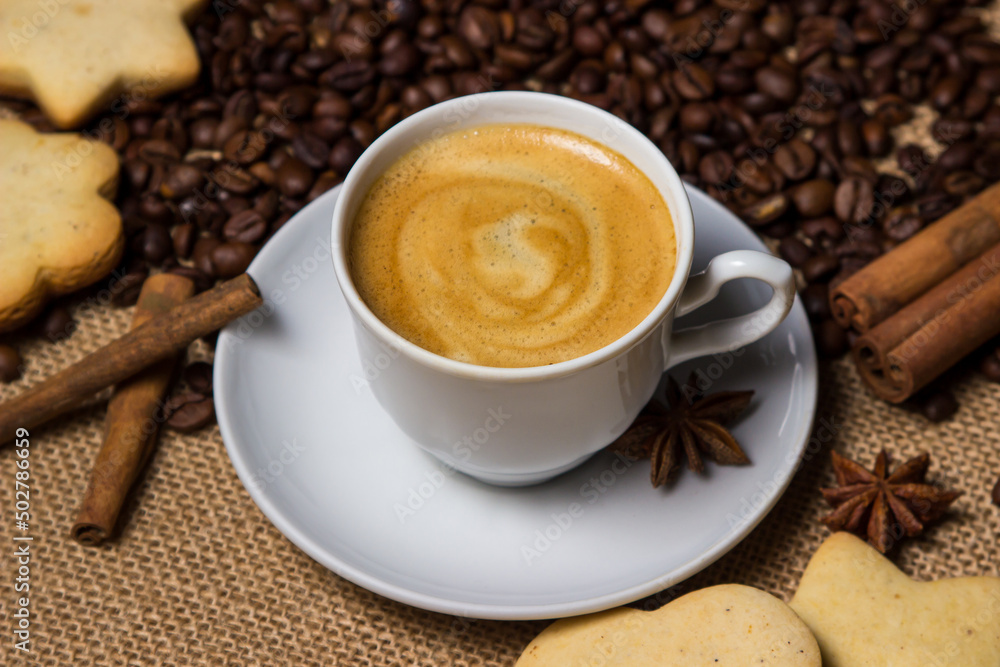 Espresso coffee on the background of coffee beans. A cup of coffee with cinnamon. invigorating drink Espresso coffee on the background of coffee beans. A cup of coffee with cinnamon. invigorating drink