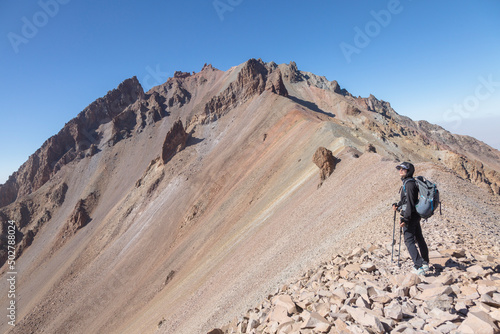 Girl tourist climbing Mount Ergies, large stratovolcano surrounded by many monogenetic vents and lava domes