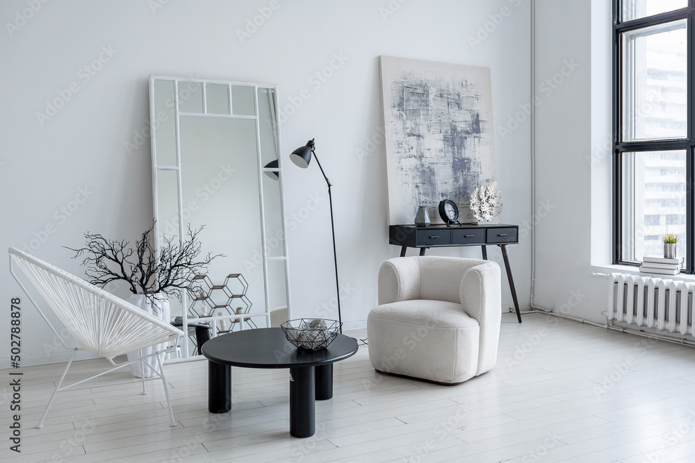 Fototapeta premium modern minimalistic interior design of light bright monochrome room with black and white furniture, clean white walls and huge windows