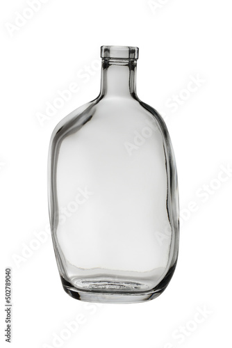 An empty, asymmetrical glass bottle for drinks. Isolated on a white background, close-up
