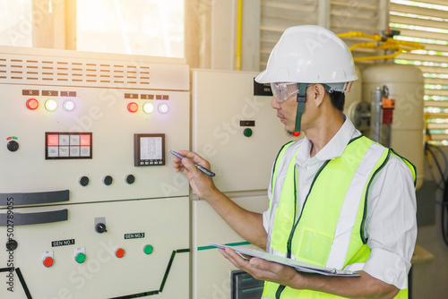 Electrical engineer holding digital multimeter, Electrical engineer is inspecting the electrical system in a factory, energy concept.