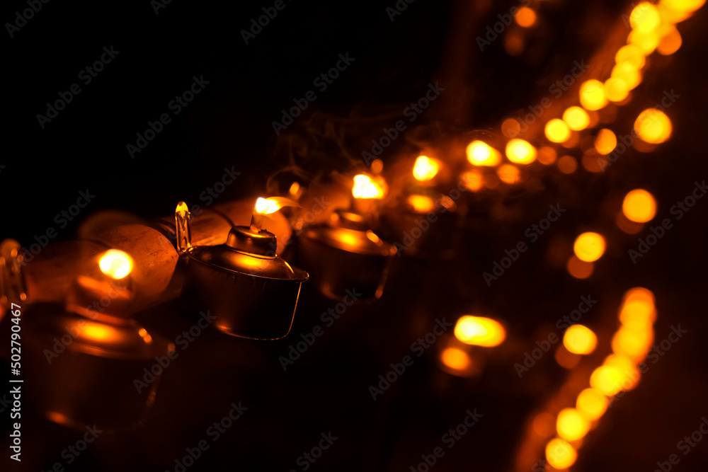 Malay tradition kerosene oil lamp or pelita in selective focus during Hari Raya Aidilfitri celebration.