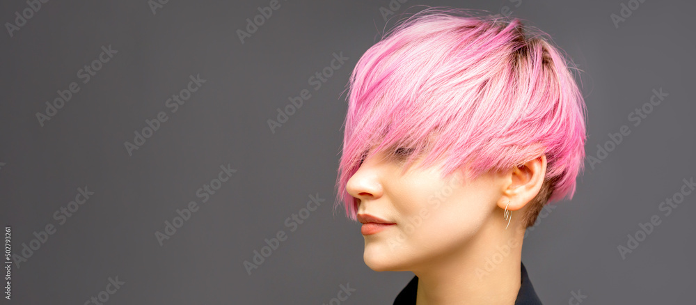 Profile of a beautiful young caucasian woman with short straight bob hairstyle dyed in pink color with closed eyes with copy space Profile of a beautiful young caucasian woman with short straight bob hairstyle dyed in pink color with closed eyes with copy space