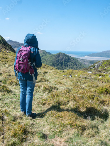 woman hiker in the Welsh Grampian mountains looking towards Barmouth in a thoughtful and aspirational way photo