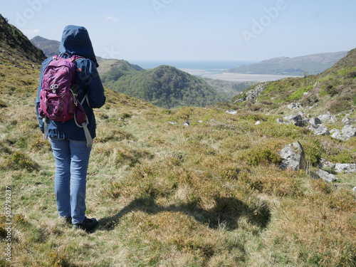 woman hiker in the Welsh Grampian mountains looking towards Barmouth in a thoughtful and aspirational way photo