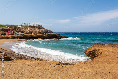 Koumbara beach with golden sand and white pebbles on Ios Island. Greece