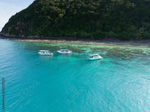 flying over the blue ocean and green island with barrier reef floating boat on summer vocation, this place call samaesarn Thailand photo