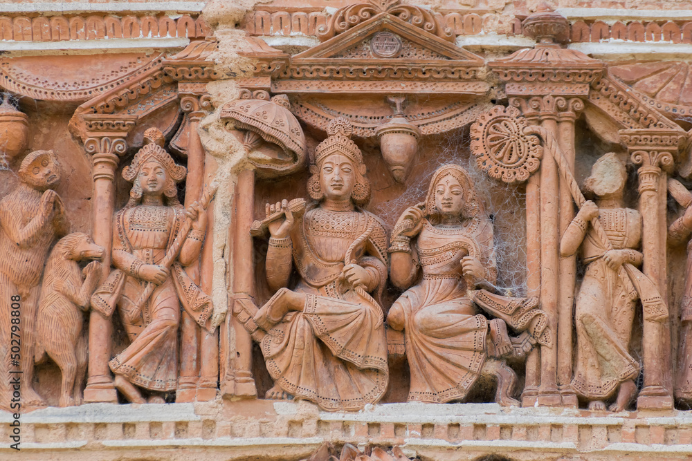 Terracotta decorations on the walls at Pratapeswar Temple at Kalna, West Bengal, India. Terracotta is a brownish-red clay that has been baked and is used for making things.