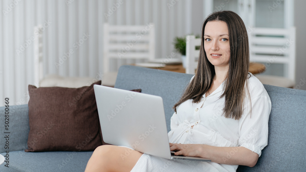 young woman with laptop sitting on the couch. young woman with laptop sitting on the couch.