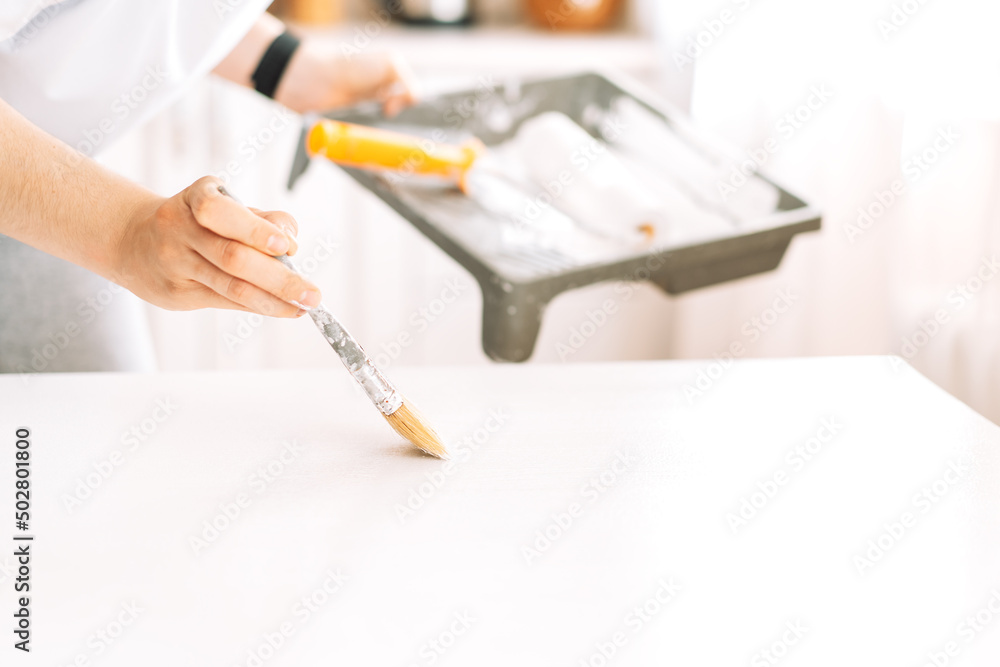 Painting wooden table white colour with brush. Painting wooden table white colour with brush.