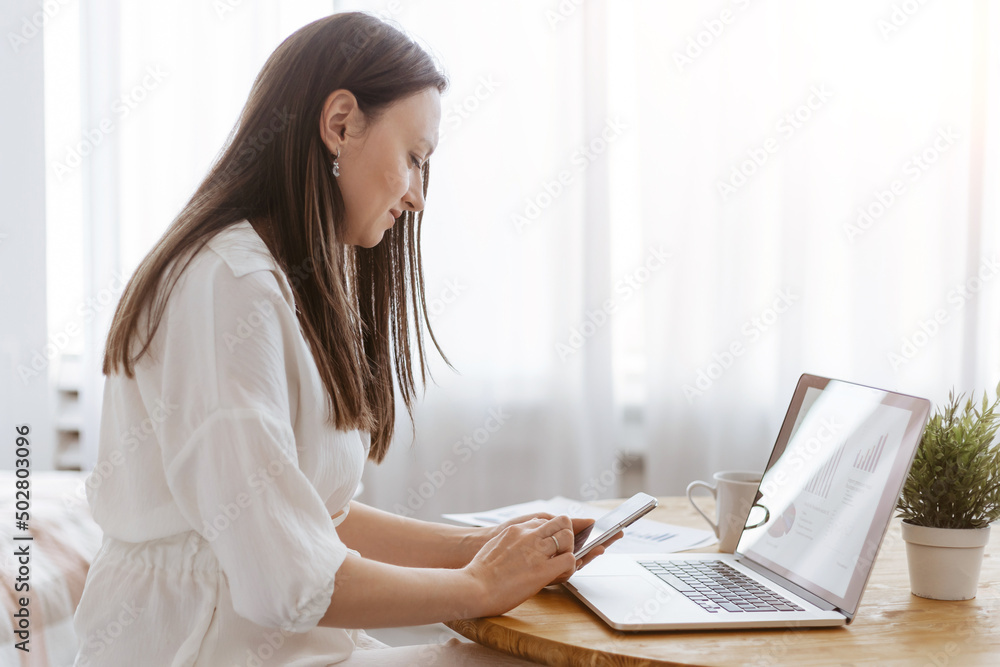 young businesswoman works in her home office. young businesswoman works in her home office.