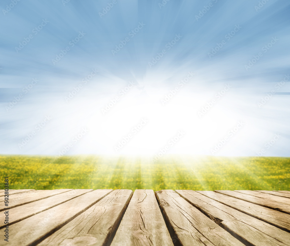 Empty Wooden Planks fields with yellow flowers and sun- bokeh for background for placing the product Empty Wooden Planks fields with yellow flowers and sun- bokeh for background for placing the product