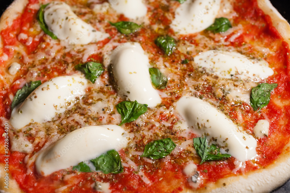 Italian homemade pizza Margherita with fresh mozzarella and basil leaves. Italian homemade pizza Margherita with fresh mozzarella and basil leaves.