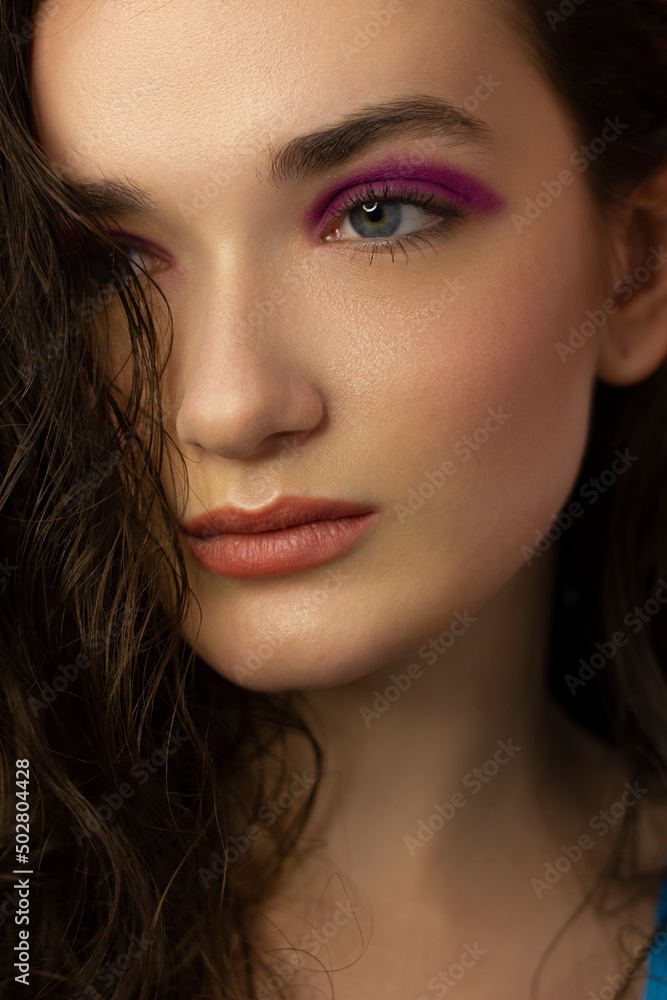 Beautiful brunet model woman face with grey eyes and perfect make-up make smile on camera. Portrait of beauty with nude lips and eyes liner, thick eyesbrow . Female face with clear skin close-up. Beautiful brunet model woman face with grey eyes and perfect make-up make smile on camera. Portrait of beauty with nude lips and eyes liner, thick eyesbrow . Female face with clear skin close-up.