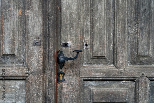 Old wooden church door and old black lock