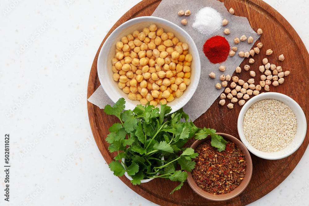 Ingredients for falafel. Chickpeas, herbs, spices, sesame seeds in bowls. Concept for middle eastern, Arabic cuisine, restaurants, menus, healthy, vegetarian and vegan lifestyle. Copy space, top view Ingredients for falafel. Chickpeas, herbs, spices, sesame seeds in bowls. Concept for middle eastern, Arabic cuisine, restaurants, menus, healthy, vegetarian and vegan lifestyle. Copy space, top view