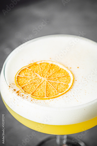 bright colored alcoholic cocktail on a black stone background