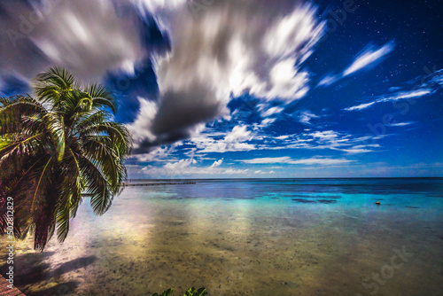 Fotografie, Obraz Moonlight Stars Clouds Night Reflection Blue Water Moorea Tahiti