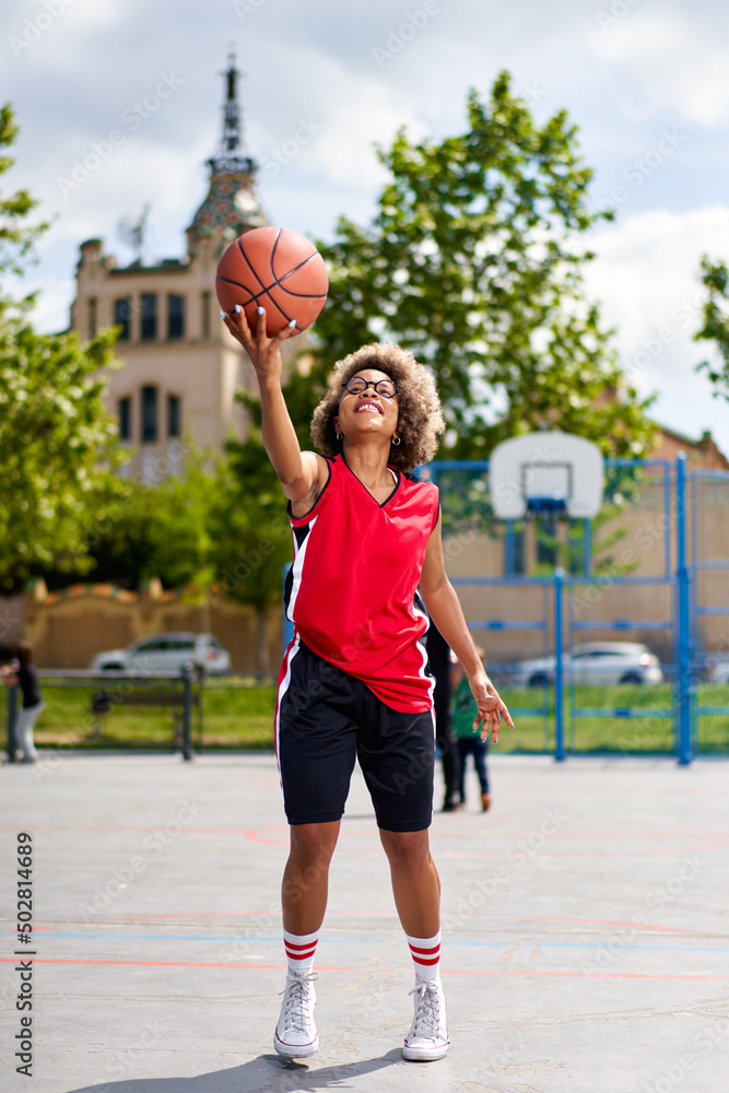 woman training outdoors on basketball court