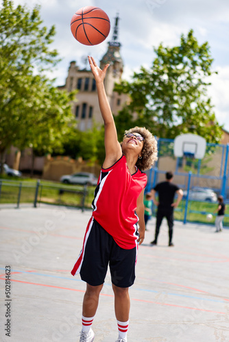 woman training outdoors on basketball court