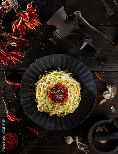 spaghetti bolognese served on wooden plate, linguini