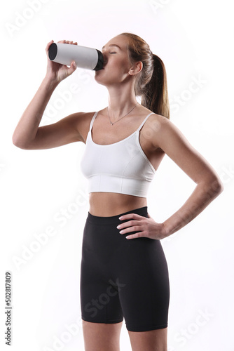Fitness woman drinking water from a bottle.