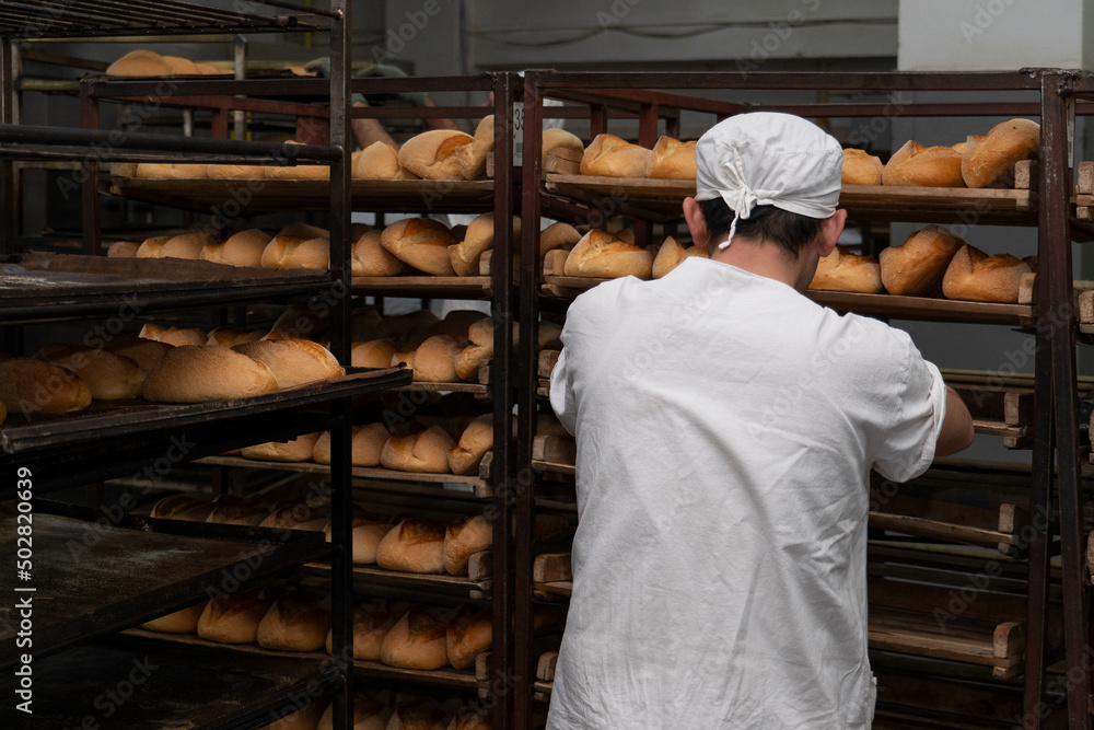 Warehouse of bread. Bakery products. A man is a bread baker. Bakery. Warehouse of bread. Bakery products. A man is a bread baker. Bakery.