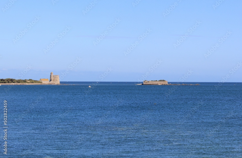 a seascape at the french coast in normandy with a vauban tower and island tatihou in the sea in saint-vaast-la-hougue