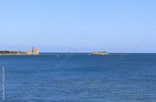 a seascape at the french coast in normandy with a vauban tower and island tatihou in the sea in saint-vaast-la-hougue