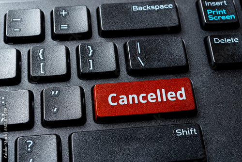 Canceled word on a red enter key of the black pc keyboard. Concepts of cancel culture, ostracism and call-out culture social media and in the Internet. Computer enter key with message.