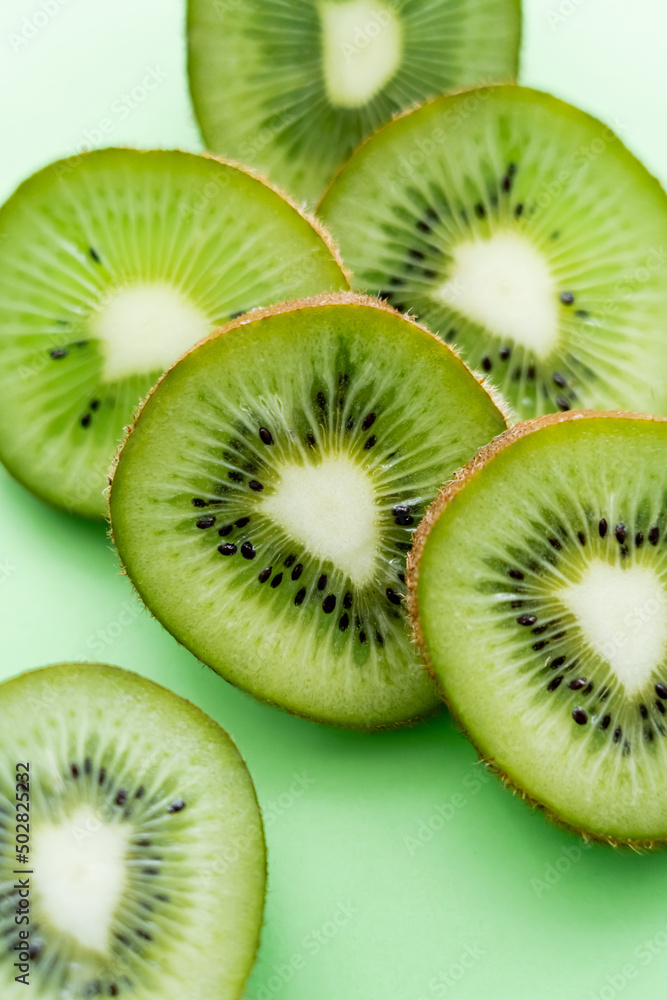 close up view of sliced and fresh kiwi on green. close up view of sliced and fresh kiwi on green.