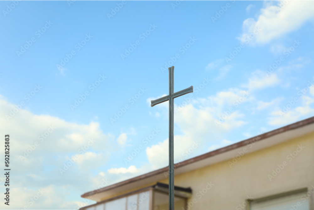 Metal Christian cross outdoors on sunny day Metal Christian cross outdoors on sunny day