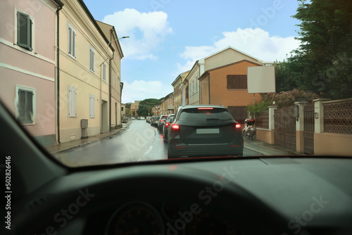 Cars in traffic jam on city street, view from driver's seat